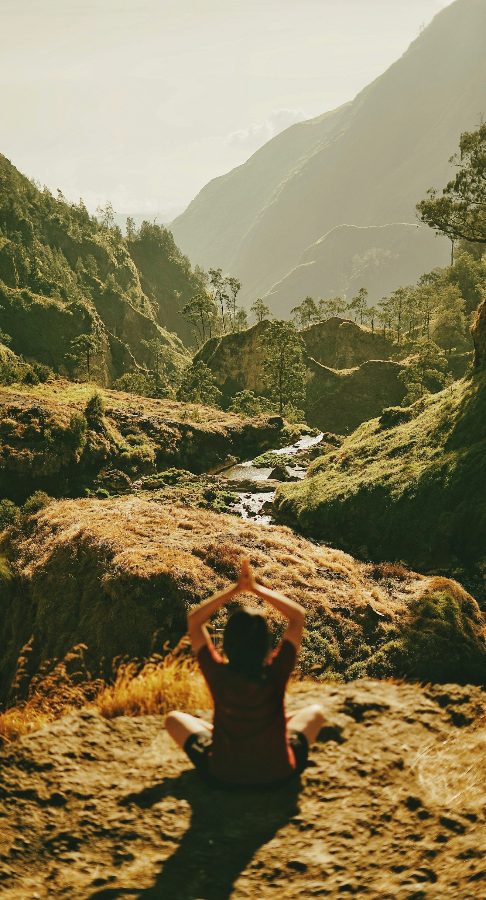 Yoga at sunrise overlooking a mountain valley