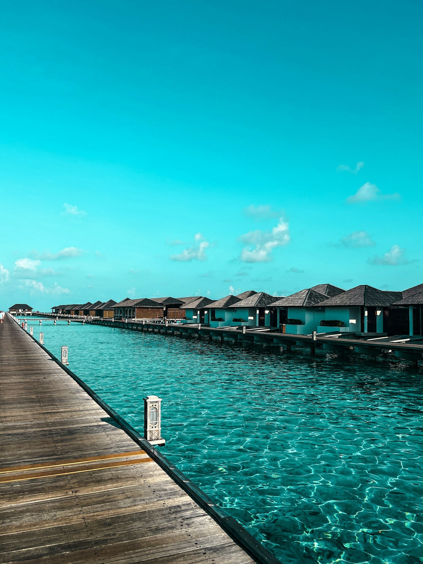 Overwater bungalows along a turquoise lagoon