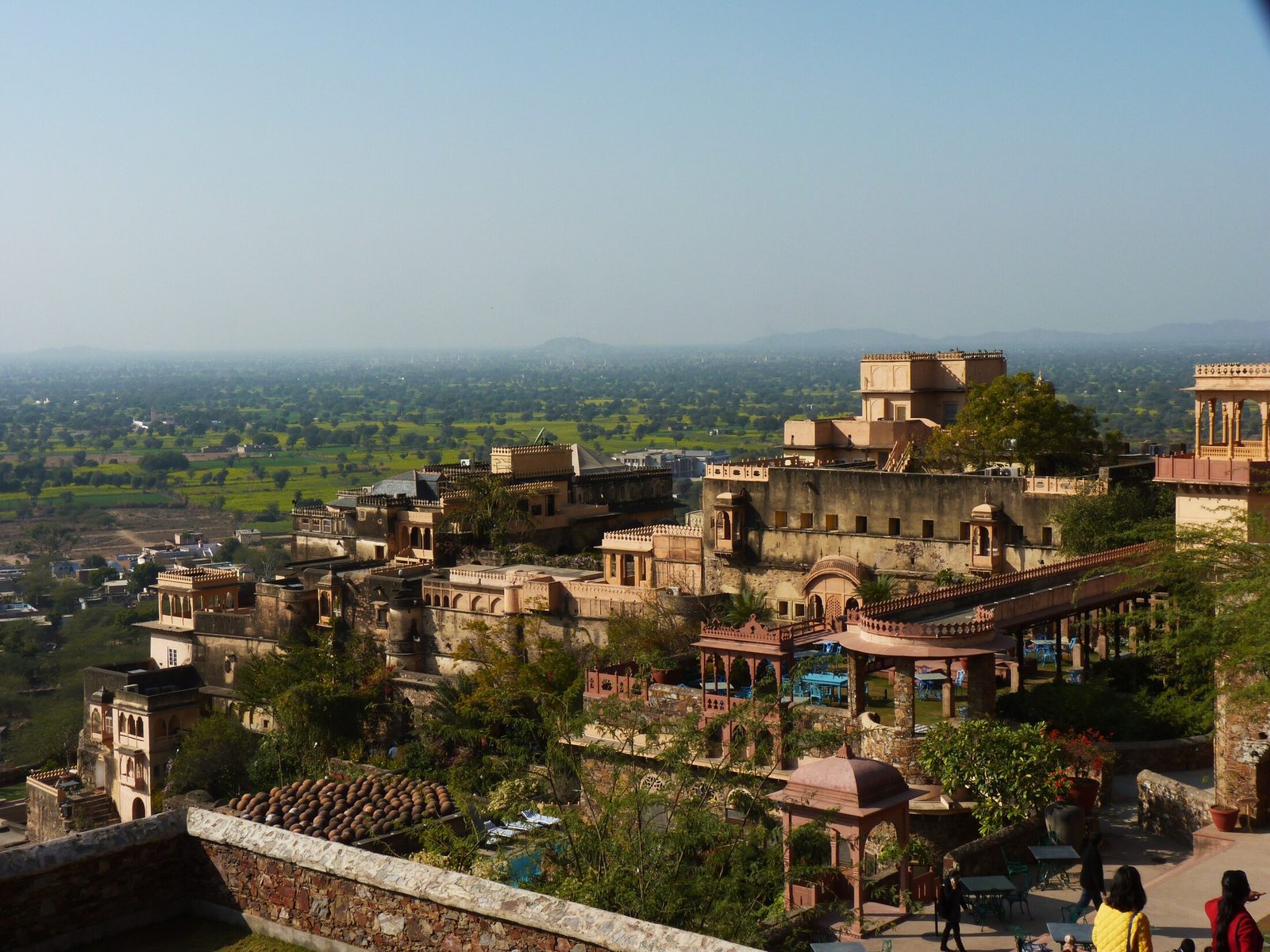 The restored Neemrana Fort-Palace stepping down its hillside above the green Rajasthan plains