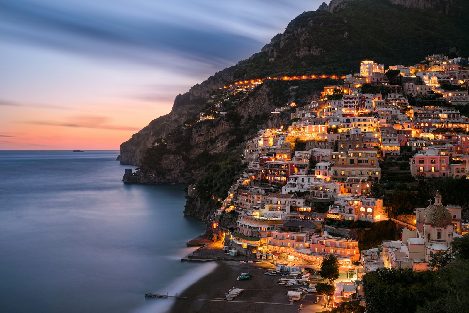 The cliffside village of Positano glowing at twilight on the Amalfi Coast