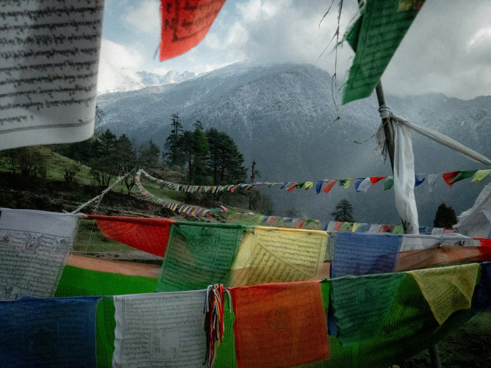 Tibetan prayer flags fluttering before snow-capped Himalayan peaks